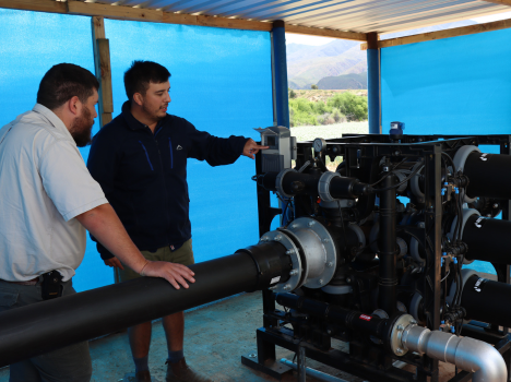 Two men discussing an irrigation filter