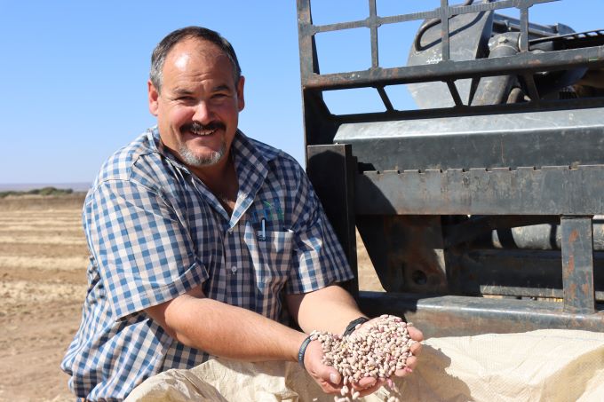 Francois Fourie holding sugar beans in his hands, showing it to the camera